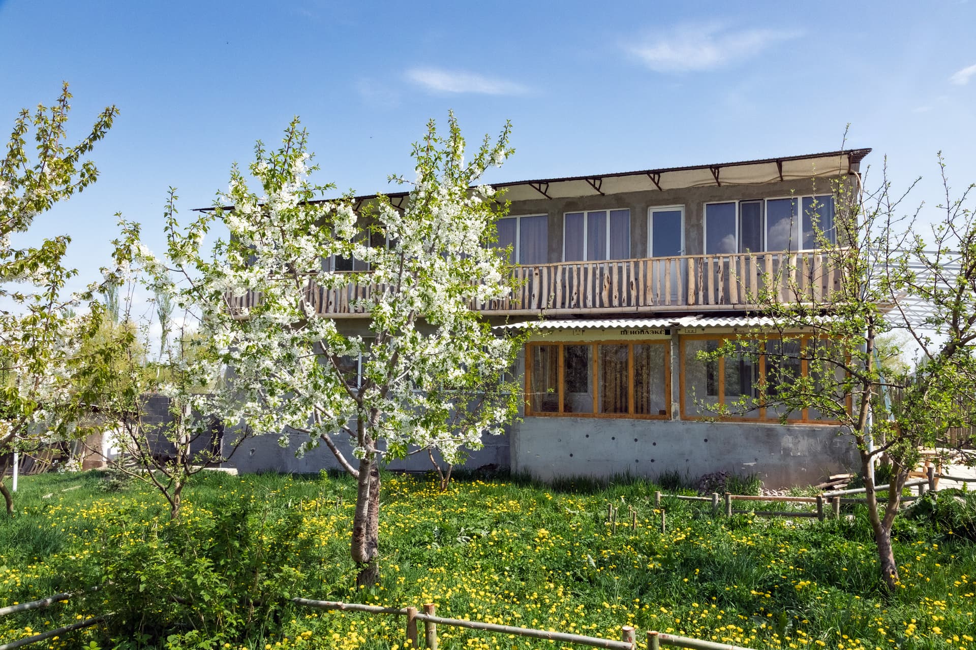 Exterior of the Svetlana Polyana guesthouse and its flower garden