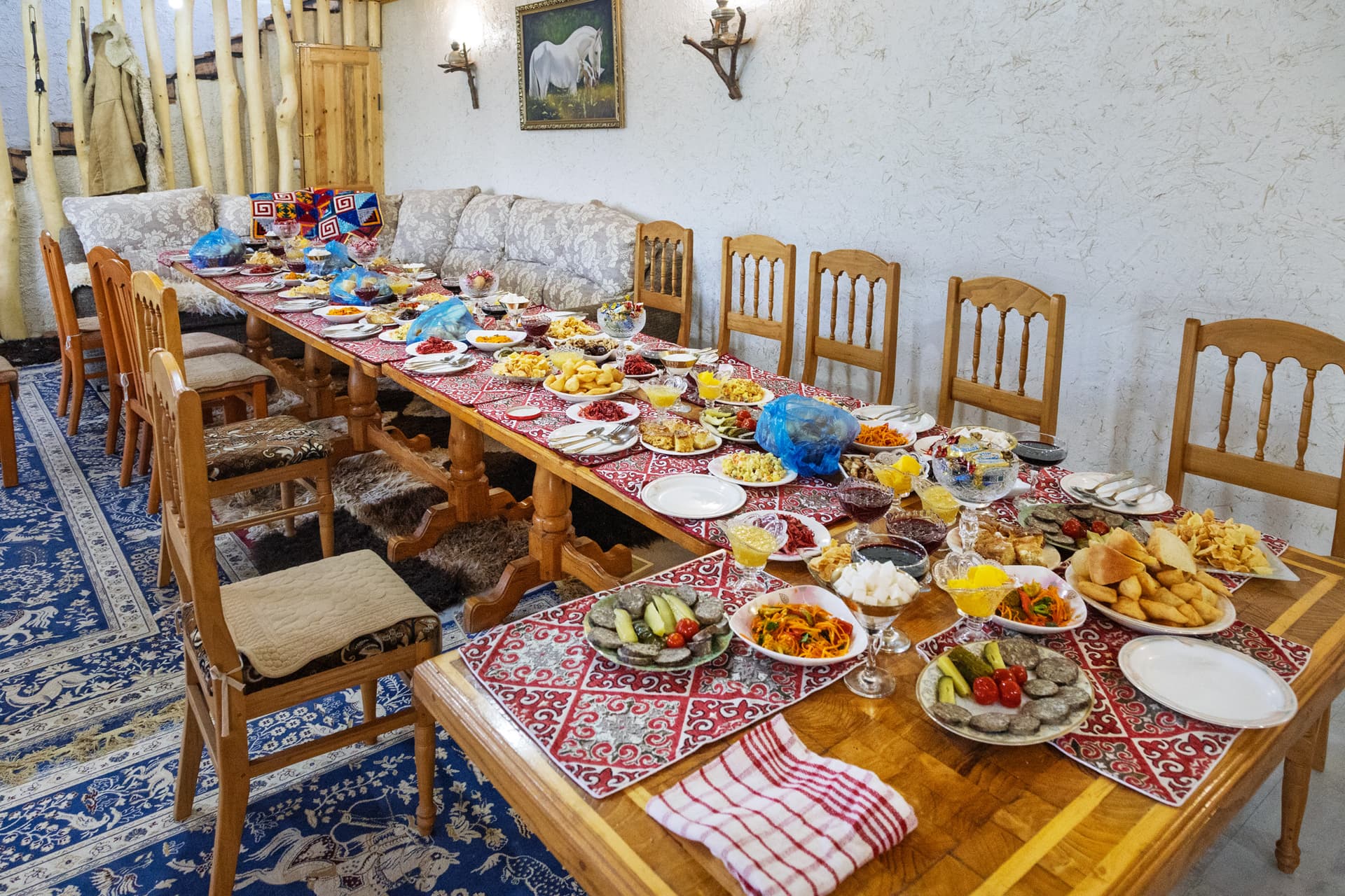 Festive table set for a banquet in Svetlana Polyana guesthouse