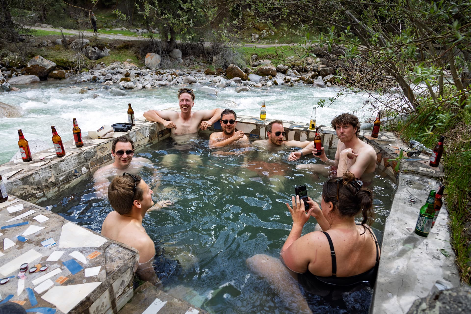 A team of friends in the outdoor pool of the Chong Kyzyl Suu hot baths