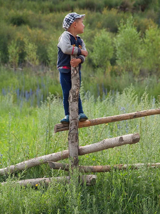 Boy on fence, Barskoon village